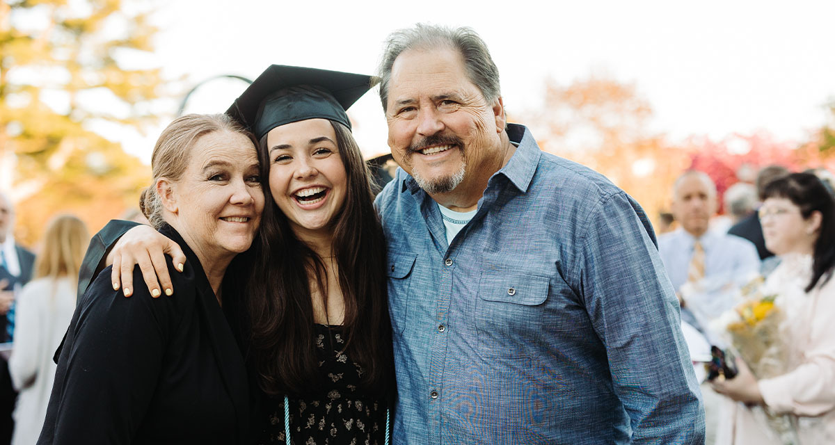 Class of 2022 Graduate Poses for a Picture with her Parents