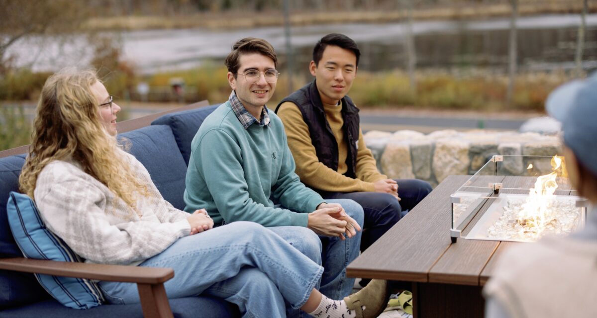 Students sitting on a couch on the Frost patio expressing gratitude.