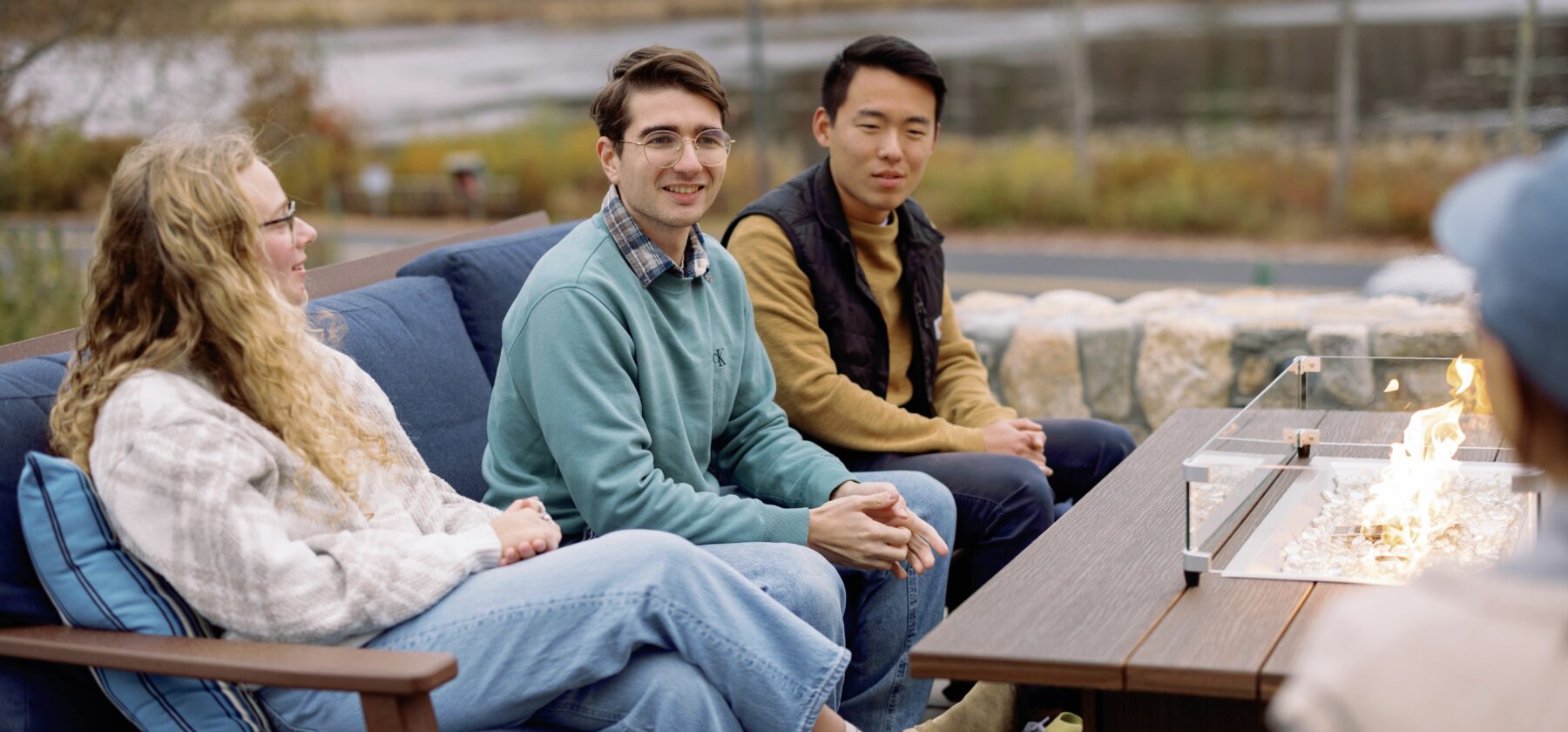 Students sitting on a couch on the Frost patio expressing gratitude.