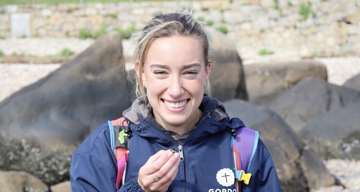 Allie Cook’ interns with penguins at the New England Aquarium.